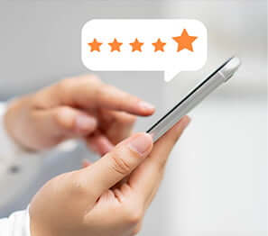 person writing a five-star review on their smartphone